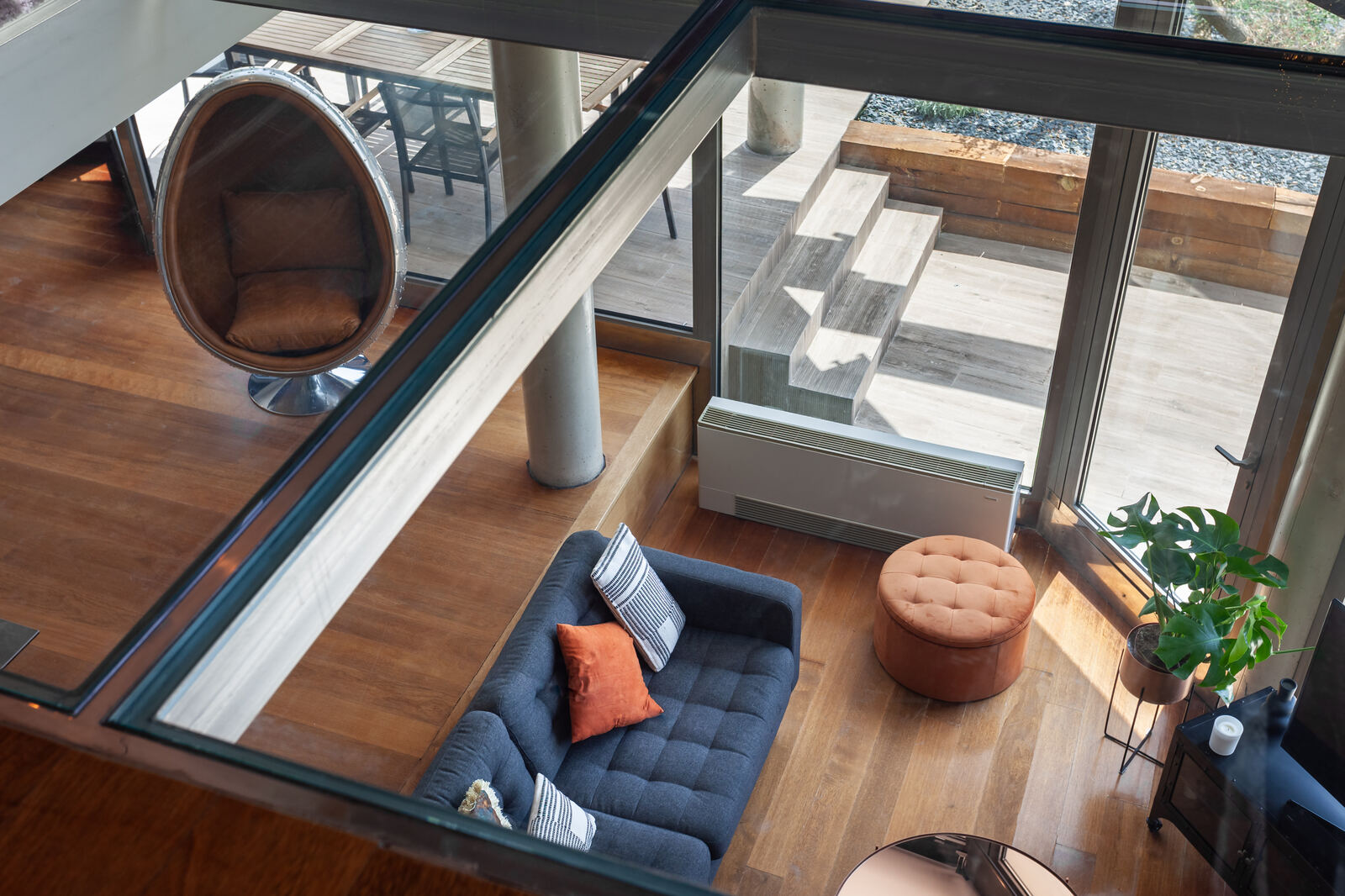 Looking down through the structural-glass mezzanine to the living room